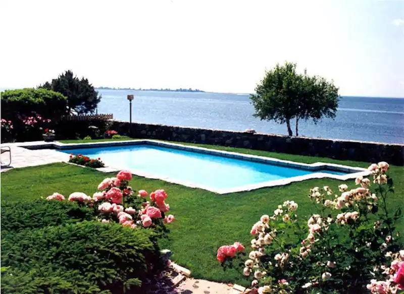 Waterfront pool with roses along the edge