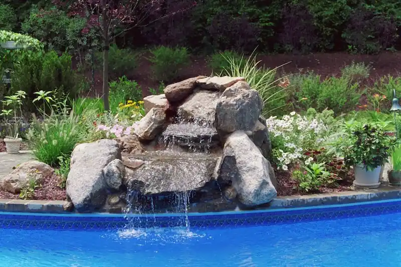 Rock waterfall pouring into a pool
