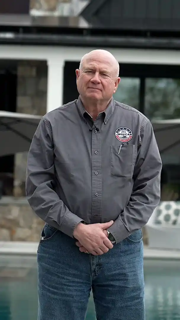 A crew member standing beside the finished pool